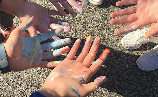 Hands with paint on them after a day of service