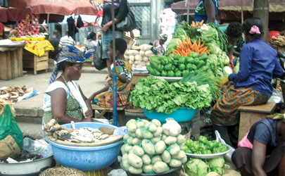 Vendors sell produce at an open-air market in Accra, Ghana